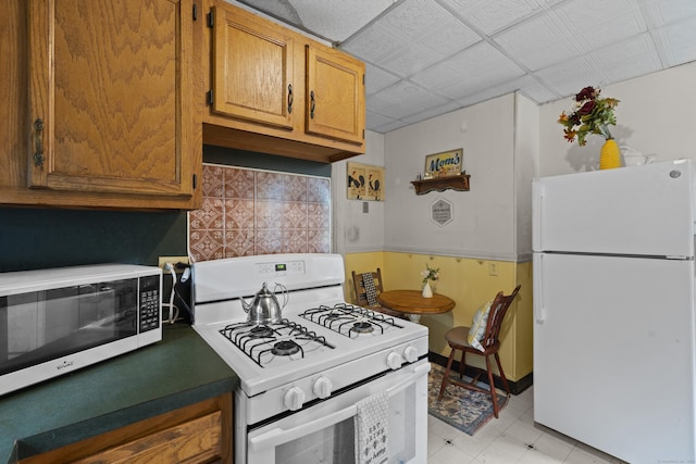 96 Melbourne Ter, Waterbury, CT 06704 - kitchen with white appliances, brown cabinets, and light floors