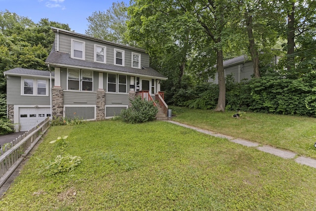 96 Melbourne Ter, Waterbury, CT 06704 - view of front of home with a shingled roof, asphalt driveway, a garage, a front yard, and stone siding