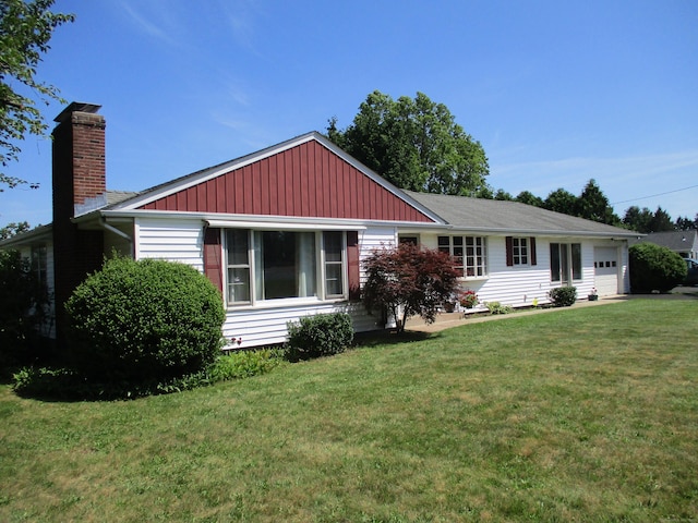 8 Susan Ln, Meriden, CT 06450 - view of front of house featuring a front lawn, a chimney, and an attached garage