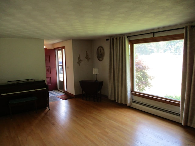 8 Susan Ln, Meriden, CT 06450 - living area with baseboard heating and wood finished floors