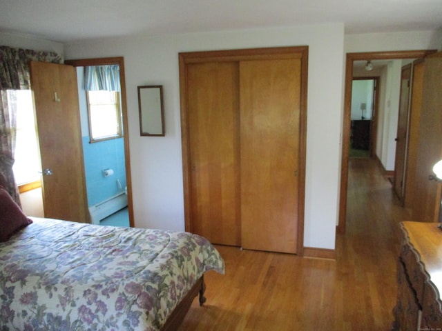 8 Susan Ln, Meriden, CT 06450 - bedroom featuring wood finished floors, a closet, and a baseboard radiator