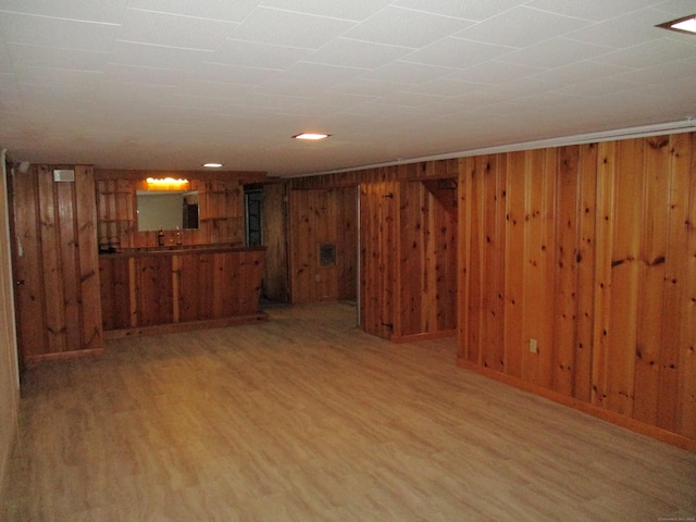 8 Susan Ln, Meriden, CT 06450 - unfurnished living room with light wood-style flooring and wooden walls