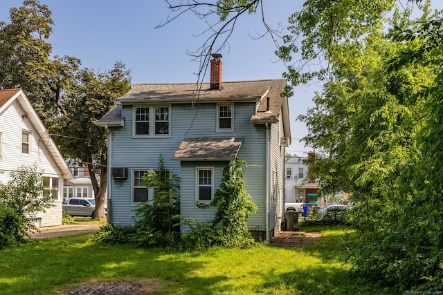 49 Richard Rd, East Hartford, CT 06119 - back of property featuring a chimney, a lawn, and roof with shingles