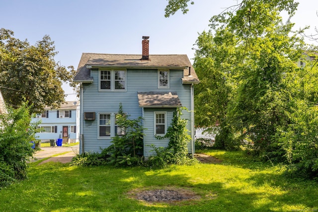 49 Richard Rd, East Hartford, CT 06119 - rear view of property featuring a chimney, a lawn, a wall mounted air conditioner, and roof with shingles