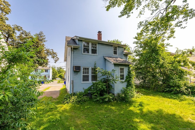 49 Richard Rd, East Hartford, CT 06119 - back of house with a chimney, a lawn, and a shingled roof