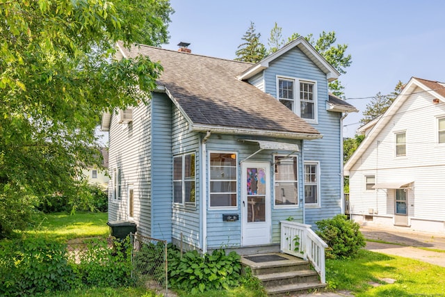 49 Richard Rd, East Hartford, CT 06119 - view of front of house with a shingled roof, a chimney, a front lawn, and a wall mounted AC