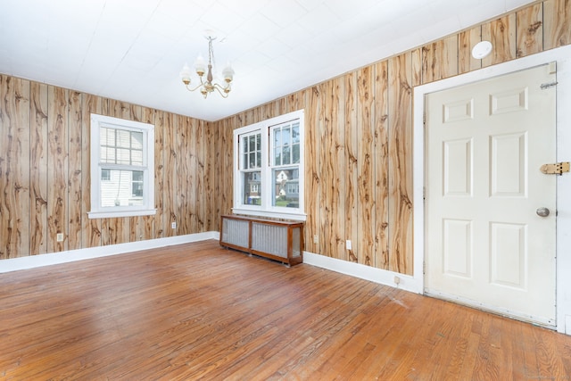 49 Richard Rd, East Hartford, CT 06119 - entrance foyer with radiator heating unit, a chandelier, wood finished floors, and wood walls