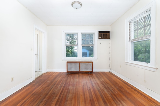 49 Richard Rd, East Hartford, CT 06119 - unfurnished room with radiator, a wall unit AC, and hardwood / wood-style floors