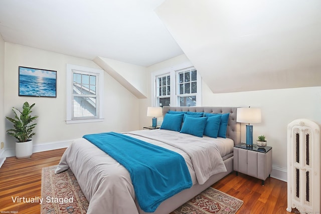 49 Richard Rd, East Hartford, CT 06119 - bedroom with radiator heating unit, wood finished floors, multiple windows, and vaulted ceiling
