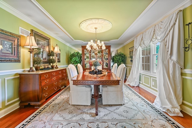 40 Hawley Rd, Danbury, CT 06811 - dining room with a chandelier, a decorative wall, wood finished floors, crown molding, and a wainscoted wall