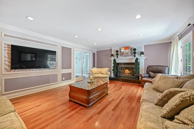 40 Hawley Rd, Danbury, CT 06811 - living area with crown molding, light wood-type flooring, a glass covered fireplace, and recessed lighting