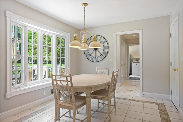 40 Hawley Rd, Danbury, CT 06811 - dining space with a chandelier, light tile patterned flooring, and washer / clothes dryer