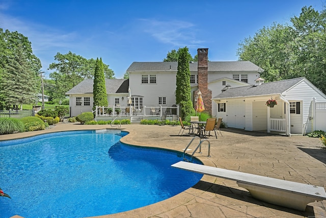 40 Hawley Rd, Danbury, CT 06811 - view of pool featuring a patio area, a deck, an outdoor structure, a diving board, and a storage structure