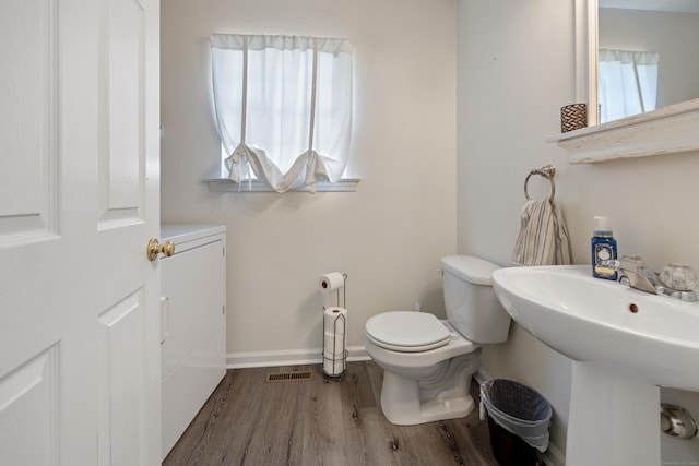 51 Schoolhouse Lndg Unit 51, East Granby, CT 06026 - half bathroom with wood finished floors and washer and clothes dryer