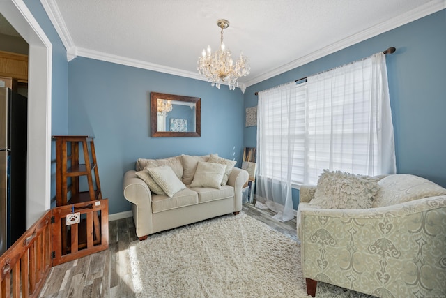 51 Schoolhouse Lndg Unit 51, East Granby, CT 06026 - living area with wood finished floors, a chandelier, and ornamental molding