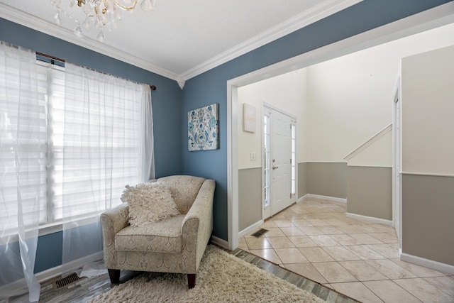 51 Schoolhouse Lndg Unit 51, East Granby, CT 06026 - living area with ornamental molding, a chandelier, and light tile patterned floors