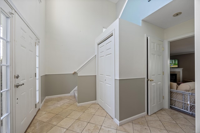 51 Schoolhouse Lndg Unit 51, East Granby, CT 06026 - foyer entrance with light tile patterned floors, stairway, and a fireplace