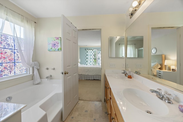 51 Schoolhouse Lndg Unit 51, East Granby, CT 06026 - ensuite bathroom featuring plenty of natural light, double vanity, and a garden tub