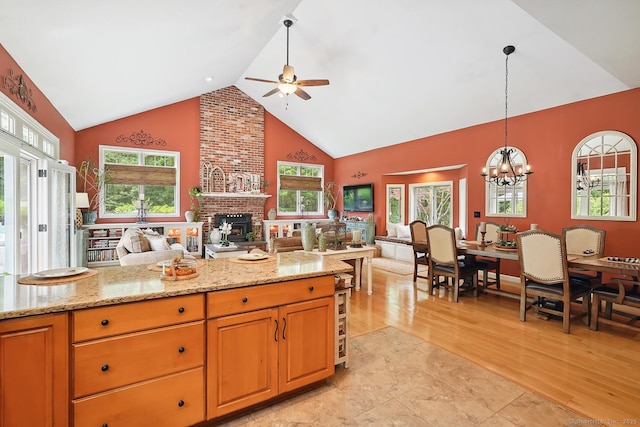 115 Center Rd, Woodstock, CT 06281 - kitchen with open floor plan, ceiling fan, high vaulted ceiling, a fireplace, and a chandelier