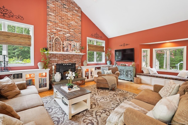 115 Center Rd, Woodstock, CT 06281 - living area featuring high vaulted ceiling, wood finished floors, and a brick fireplace