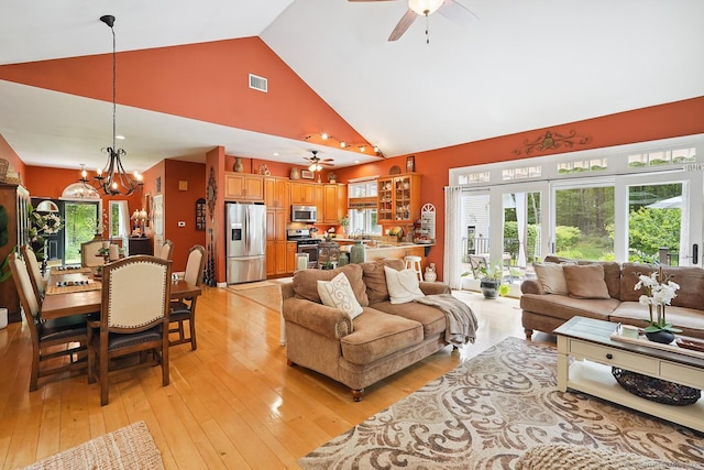 115 Center Rd, Woodstock, CT 06281 - living room with ceiling fan, high vaulted ceiling, light wood-style flooring, and a chandelier
