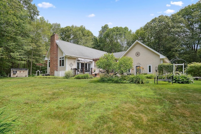 115 Center Rd, Woodstock, CT 06281 - view of front facade featuring a storage unit, a front lawn, and a chimney