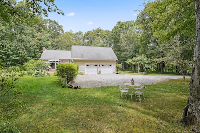 115 Center Rd, Woodstock, CT 06281 - view of side of property featuring driveway, a garage, a yard, and a chimney