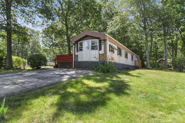 28 Nashua St, Norwich, CT 06360 - manufactured / mobile home with a front yard, driveway, and a wooden deck