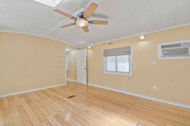 28 Nashua St, Norwich, CT 06360 - spare room with ceiling fan, a wall unit AC, wood finished floors, crown molding, and lofted ceiling