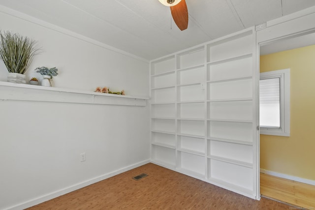 28 Nashua St, Norwich, CT 06360 - spare room featuring wood finished floors, built in shelves, and a ceiling fan