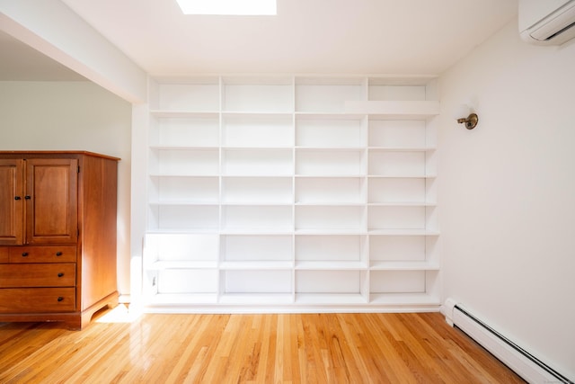 25 Old Middle Rd, Brookfield, CT 06804 - interior space with a baseboard radiator, an AC wall unit, and light wood-type flooring