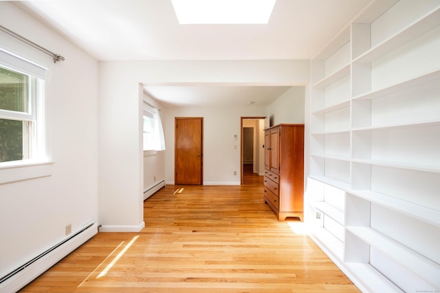 25 Old Middle Rd, Brookfield, CT 06804 - empty room with a baseboard heating unit, light wood finished floors, a skylight, and built in features