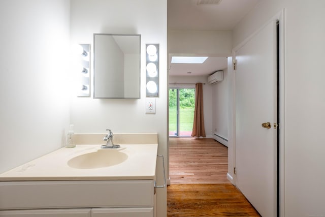 25 Old Middle Rd, Brookfield, CT 06804 - bathroom featuring an AC wall unit, a baseboard radiator, wood finished floors, vanity, and a skylight