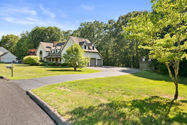 18 Sandpiper Ln, East Lyme, CT 06333 - view of front of house featuring driveway, a garage, a front yard, and a chimney