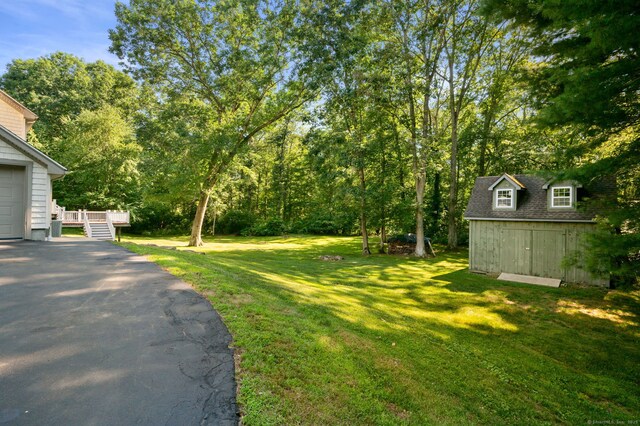 18 Sandpiper Ln, East Lyme, CT 06333 - view of grassy yard with an outdoor structure and asphalt driveway