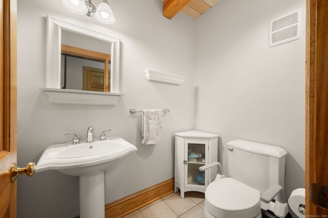 18 Sandpiper Ln, East Lyme, CT 06333 - half bathroom with tile patterned floors and beam ceiling