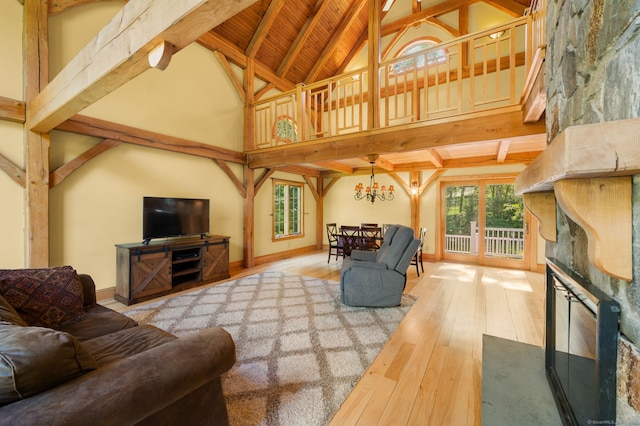 18 Sandpiper Ln, East Lyme, CT 06333 - living area featuring plenty of natural light, hardwood / wood-style floors, a chandelier, high vaulted ceiling, and a fireplace