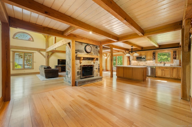 18 Sandpiper Ln, East Lyme, CT 06333 - unfurnished living room featuring light wood finished floors, a fireplace, plenty of natural light, and beam ceiling