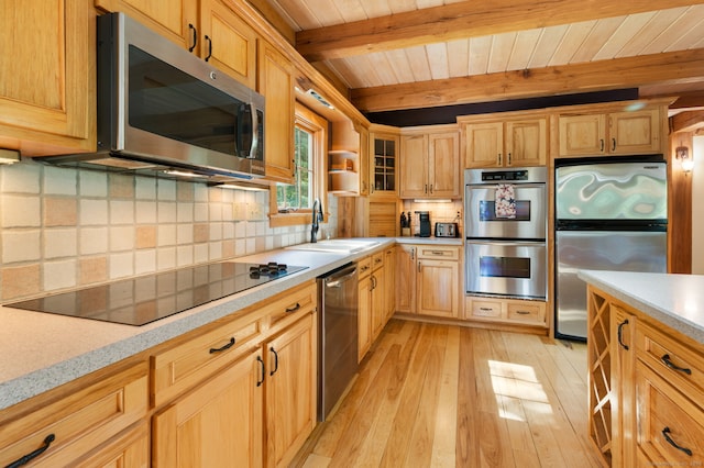 18 Sandpiper Ln, East Lyme, CT 06333 - kitchen featuring appliances with stainless steel finishes, light wood finished floors, light countertops, a wooden ceiling with exposed beams, and backsplash
