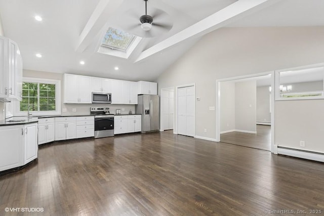 6 Kingsbury Rd, Norwalk, CT 06851 - kitchen featuring appliances with stainless steel finishes, dark countertops, a ceiling fan, beam ceiling, and a skylight