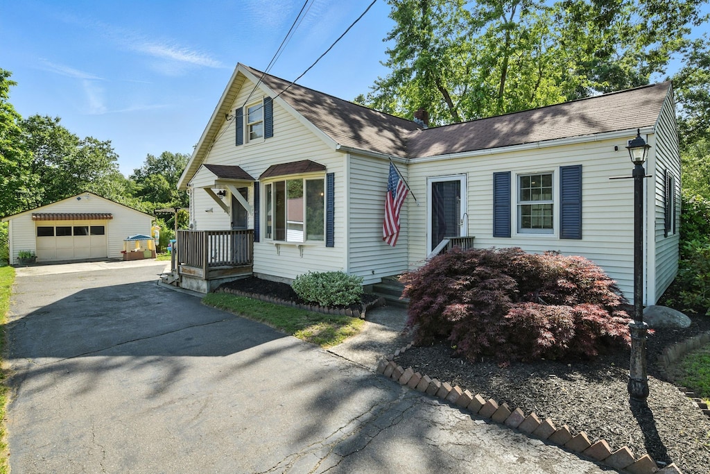 254 Elm St, Enfield, CT 06082 - view of front of property with an outbuilding, asphalt driveway, and a garage