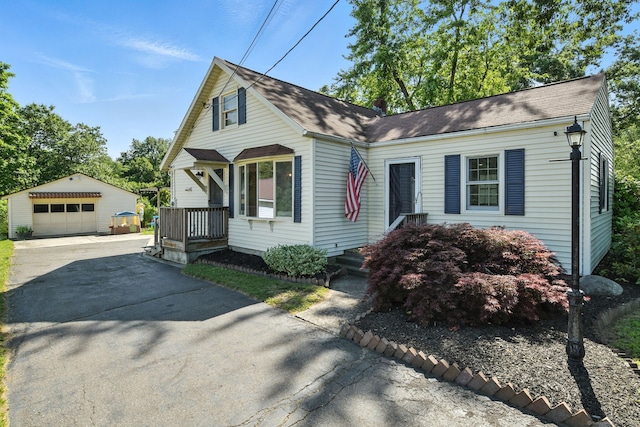 254 Elm St, Enfield, CT 06082 - view of front of property with an outbuilding, asphalt driveway, and a garage