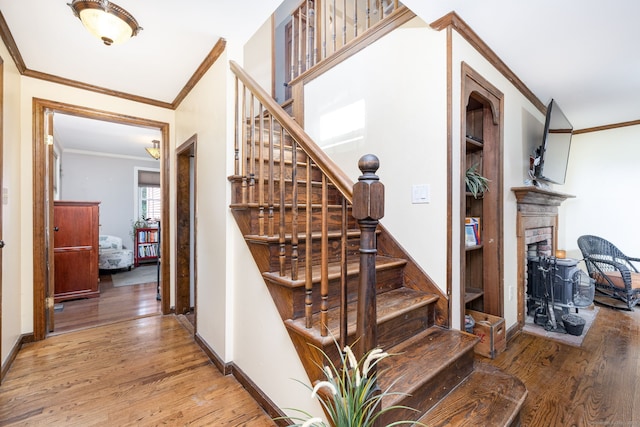 26 Skyview Ter, Bristol, CT 06010 - staircase with crown molding, wood finished floors, and a fireplace with raised hearth