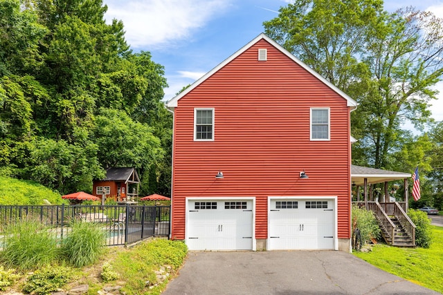 26 Skyview Ter, Bristol, CT 06010 - view of side of home with driveway, an attached garage, and stairway