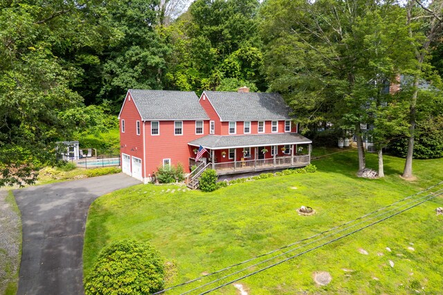 26 Skyview Ter, Bristol, CT 06010 - view of front of property featuring a porch, asphalt driveway, an attached garage, a front yard, and roof with shingles