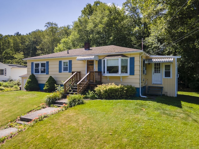 15 Denis Dr, Thompson, CT 06255 - bungalow-style home with a front lawn, entry steps, and a chimney