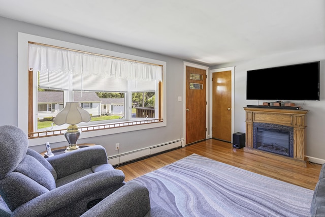15 Denis Dr, Thompson, CT 06255 - living room featuring baseboard heating, wood finished floors, and a fireplace