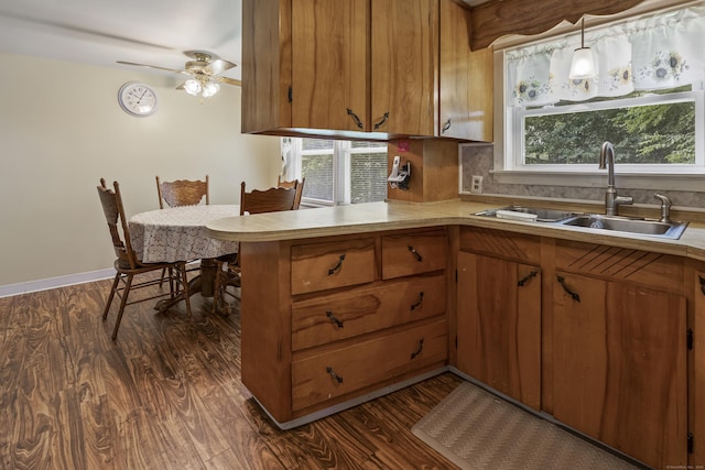 15 Denis Dr, Thompson, CT 06255 - kitchen with light countertops, brown cabinets, a peninsula, and dark wood-type flooring