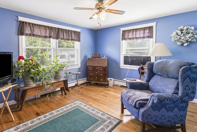 15 Denis Dr, Thompson, CT 06255 - sitting room featuring cooling unit, ceiling fan, wood finished floors, and a baseboard radiator