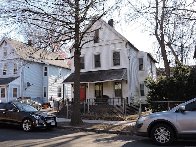 188 Hazel St, New Haven, CT 06511 - american foursquare style home featuring a porch, a chimney, and a fenced front yard